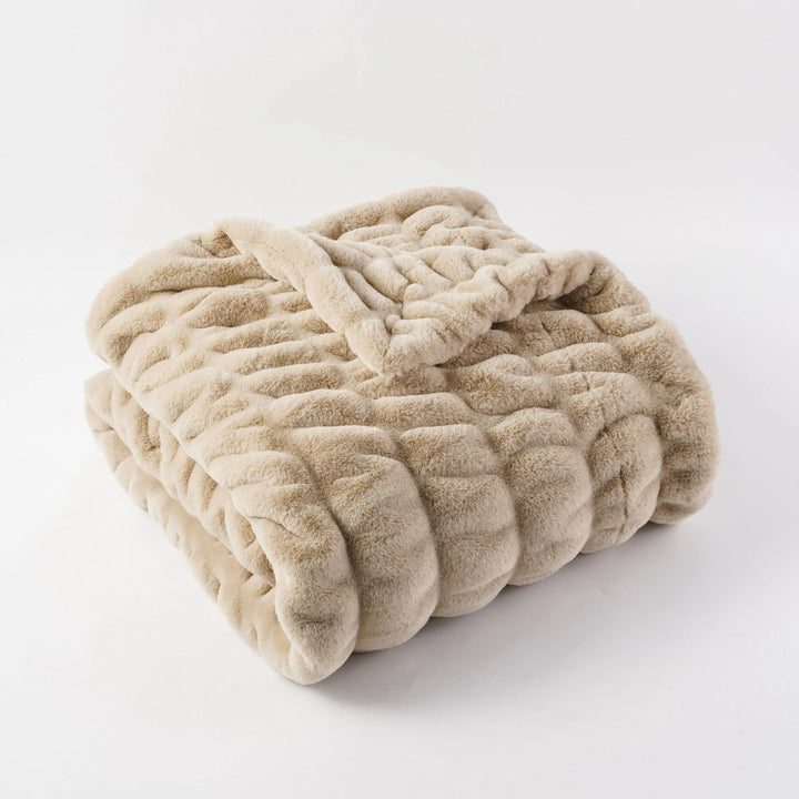 Faux fur throw blanket, perfect for adding a touch of elegant, soft comfort to any room.