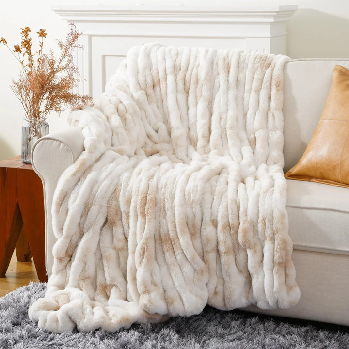 Elegant faux fur throw blanket, bringing luxurious comfort and warmth to your space.