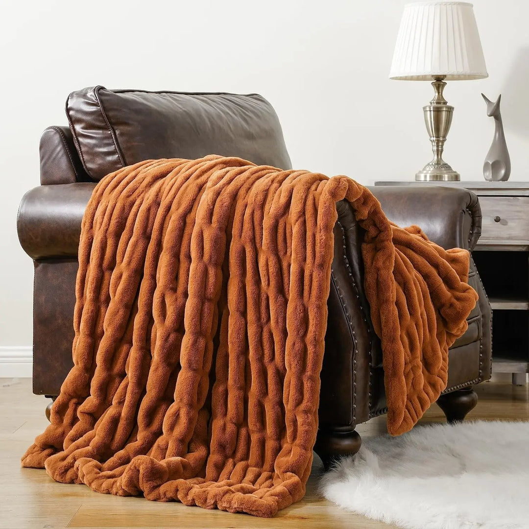 Home decor accent: elegant faux fur throw blanket, soft and inviting.