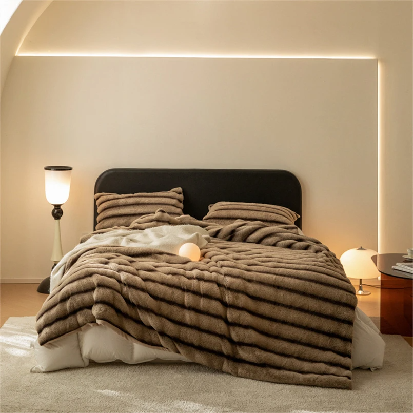 Soft faux rabbit fur throw blanket, providing exceptional warmth and a luxurious feel. Ideal for living room.