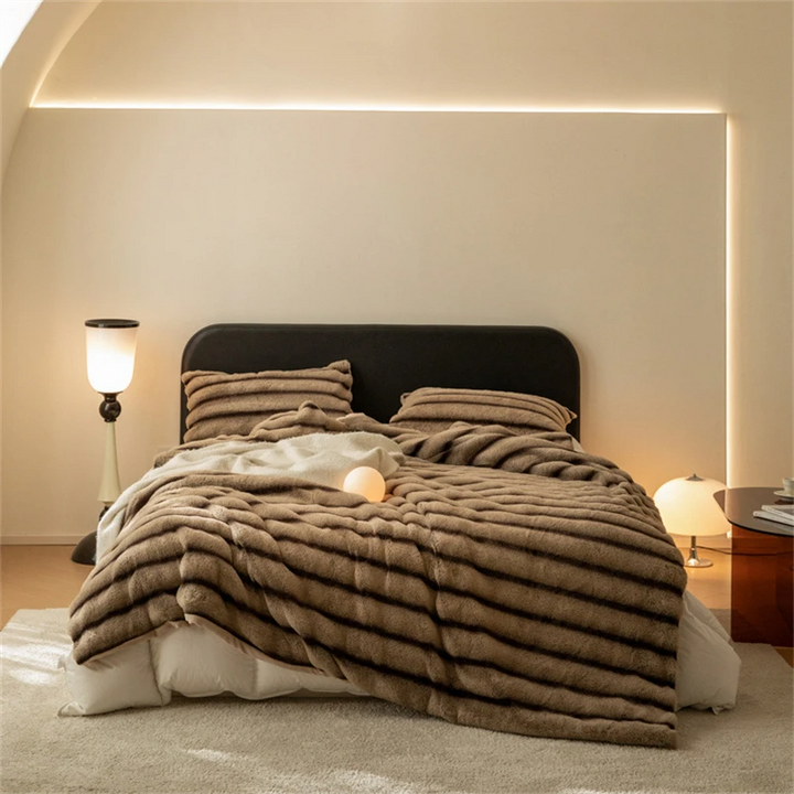 Soft faux rabbit fur throw blanket, providing exceptional warmth and a luxurious feel. Ideal for living room.