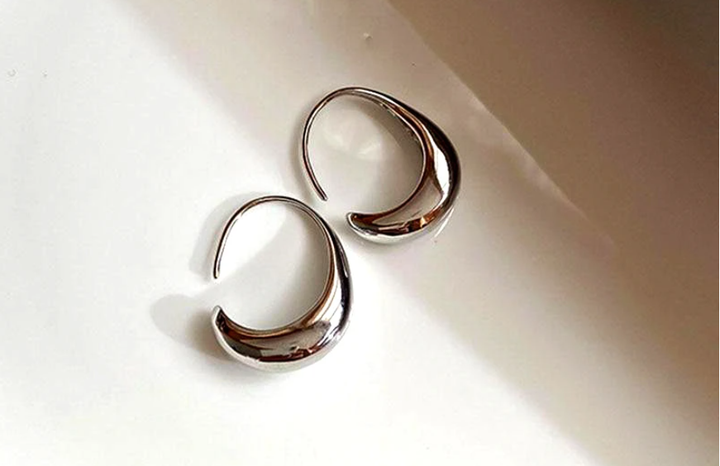Elegant silver hoop earrings for women, minimalist design for versatile luxury fashion. A must-have jewelry accessory.