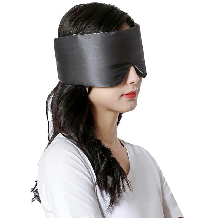 Comfortable unisex silk sleep mask for travel. Blocks light, promotes relaxation & deep rest on the go.