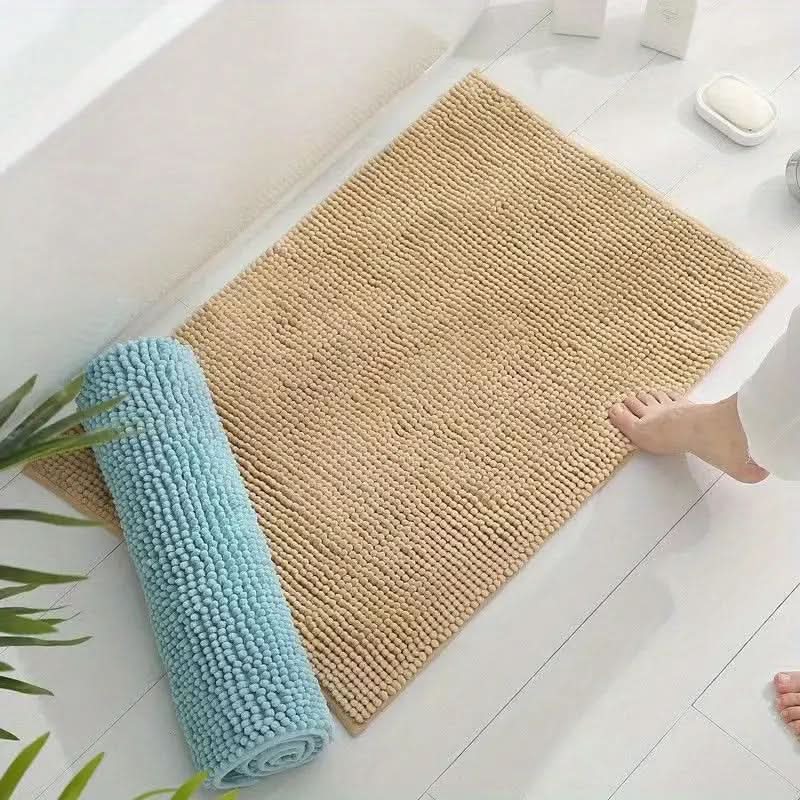 Absorbent chenille bath rug, soft plush texture with non-slip backing for comfort and safety.