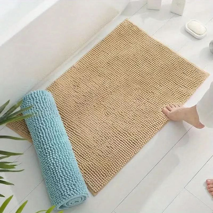 Absorbent chenille bath rug, soft plush texture with non-slip backing for comfort and safety.