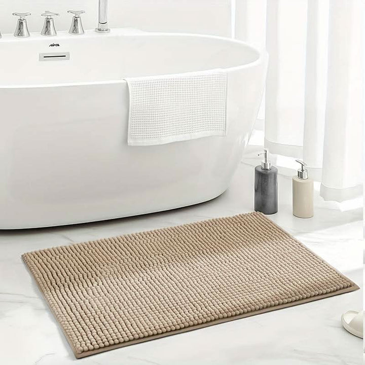 Soft chenille bath rug, highly absorbent and non-slip, essential for a cozy and safe bathroom.