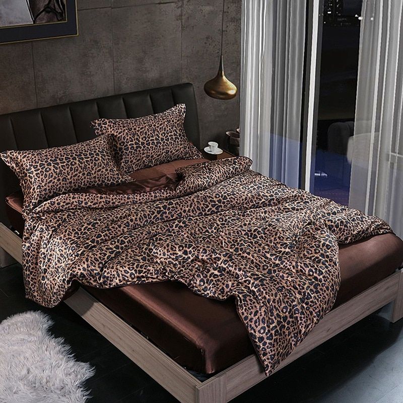 Folded luxurious 4-piece silk-satin bedding set, emphasizing soft texture and quality