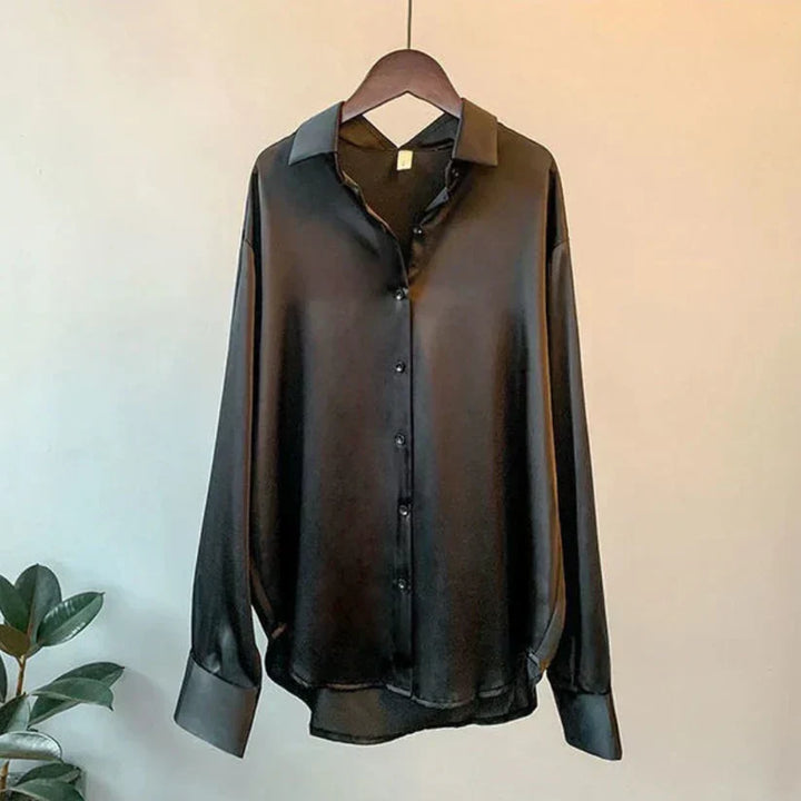 Luxurious silky satin women's blouse. Elegant long-sleeve top, perfect for sophisticated workwear or stylish occasions.