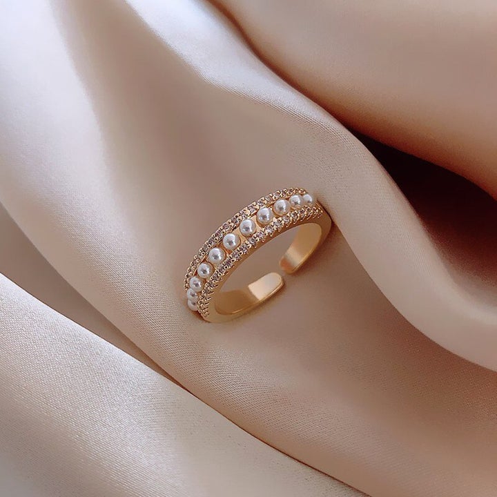 Luxurious women's gold ring featuring a prominent, shimmering pearl. Elegant pearl jewelry, ideal for special occasions or gifts.