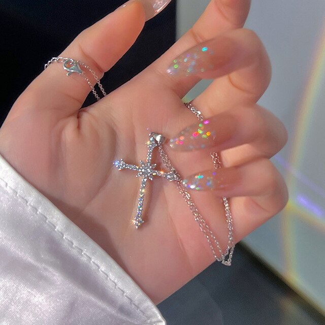 Luxurious women's silver necklace with sparkling zircon crystal cross pendant. Elegant religious jewelry piece.