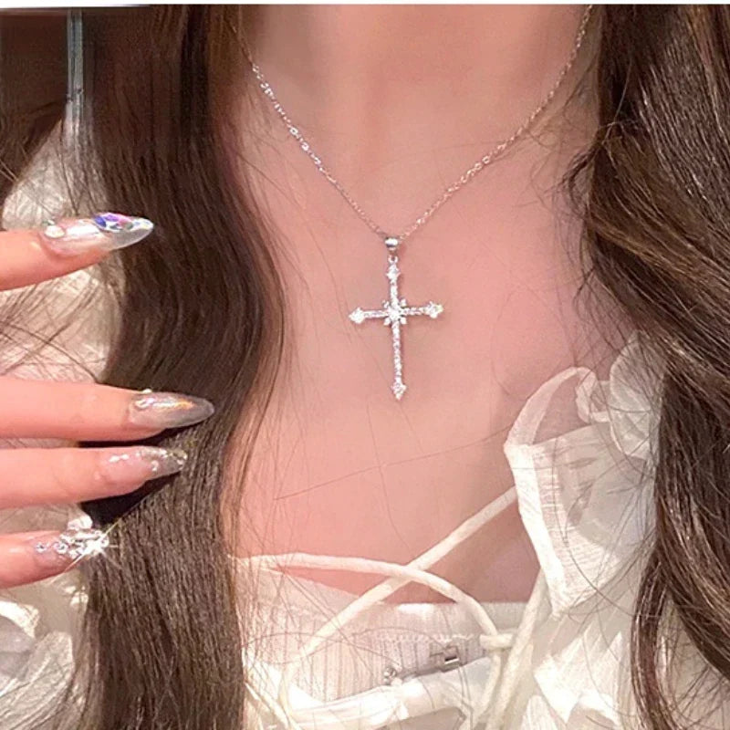 Close-up of a dazzling zircon crystal cross pendant on a delicate silver necklace for women. Elegant and spiritual.