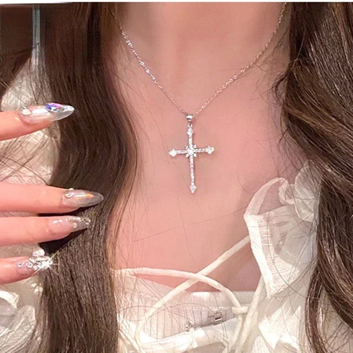 Close-up of a dazzling zircon crystal cross pendant on a delicate silver necklace for women. Elegant and spiritual.