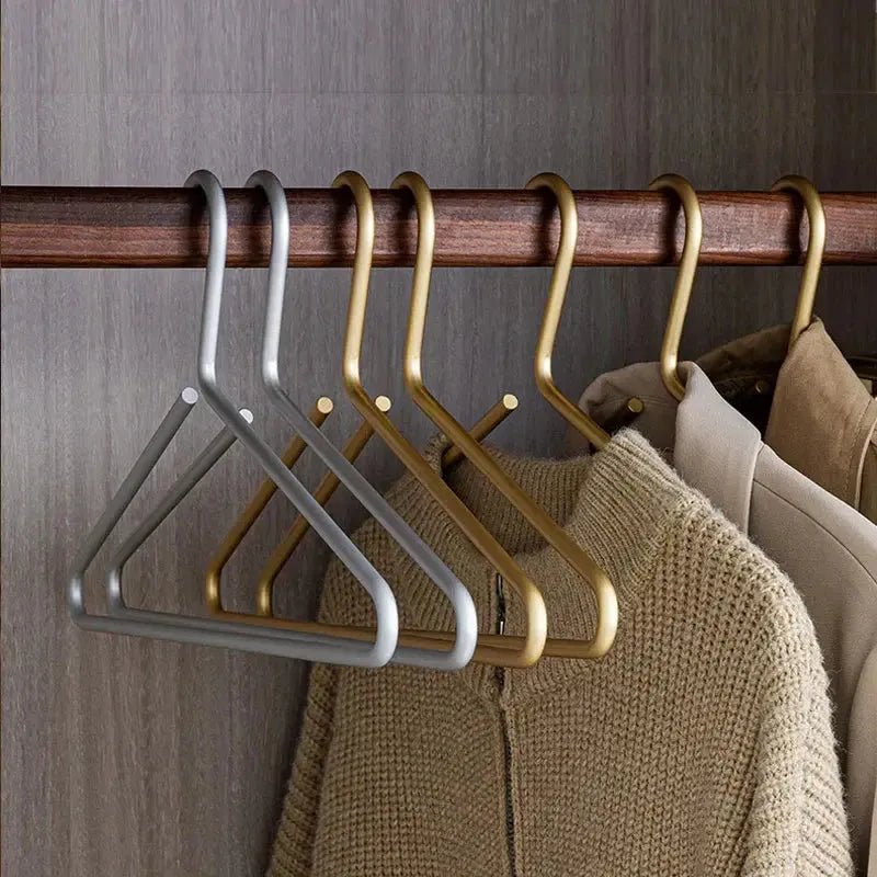 Set of luxury gold anti-slip metal hangers, enhancing wardrobe organization. Ideal for various garments.