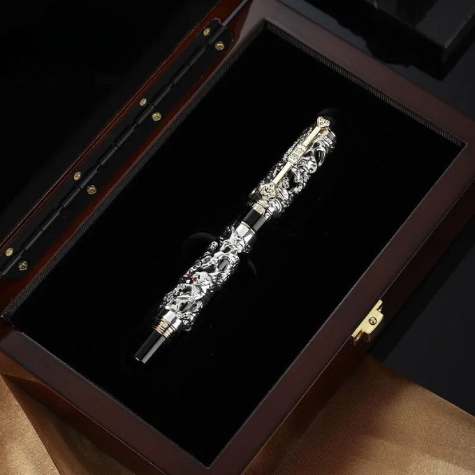Close-up of the intricate dragon sculpture on a luxury executive fountain pen.