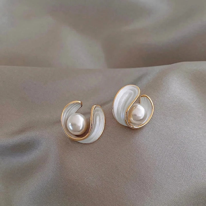 Luxury gold drop earrings with white opals and luminous pearls for women. Elegant special occasion jewelry.