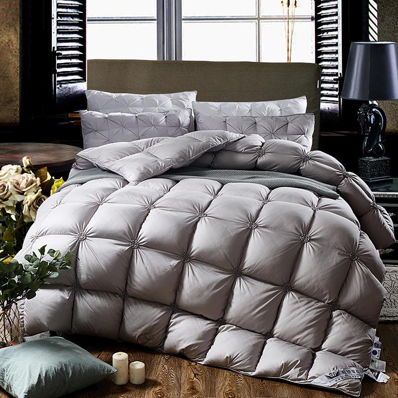 Close-up: Luxurious white PlumeLux goose down duvet with elegant piped edging & soft cotton cover texture.