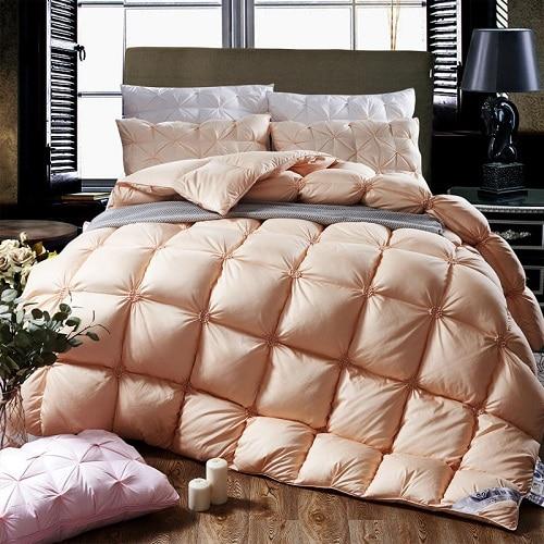 Folded PlumeLux luxury 100% goose down duvet with piped edging, white cotton cover for warmth & soft bedding.