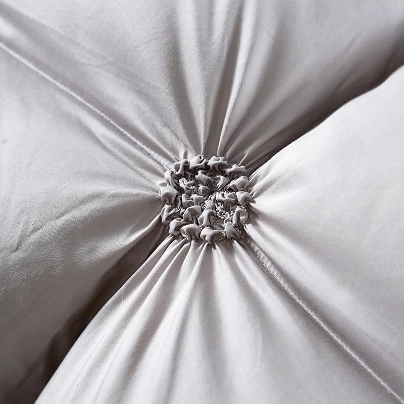 Stack of luxurious PlumeLux 100% goose down duvets, offering all-season comfort, soft bedding & warmth.