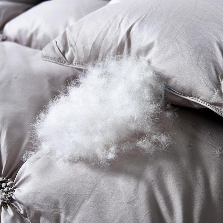 Inviting bed with a soft, warm PlumeLux luxury goose down duvet, perfect for all-season sleep comfort.