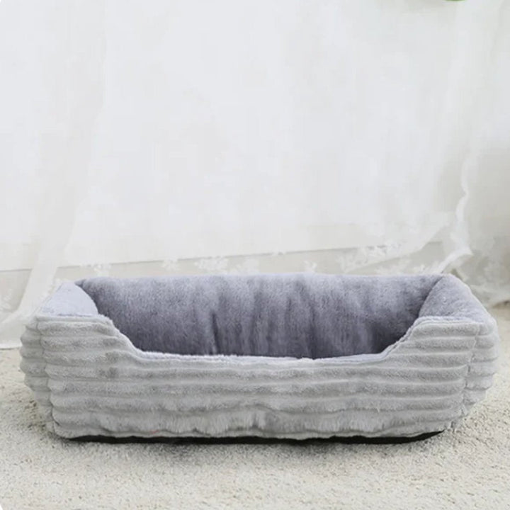 Washable plush pet bed, cozy comfort for cats & small dogs. Soft, non-slip luxury design.