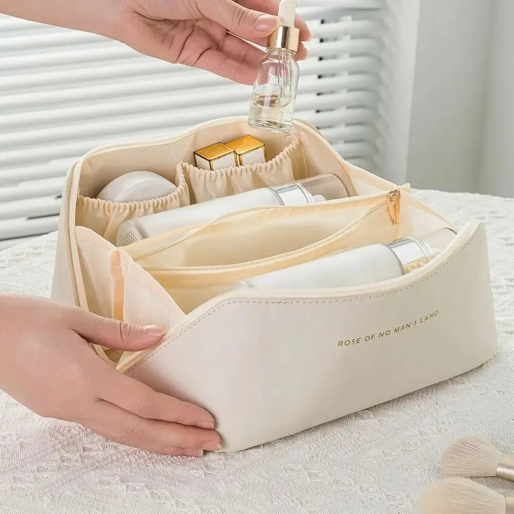 Organized interior of a women's travel cosmetic case, showcasing neat storage for makeup brushes and products.