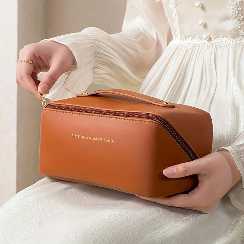 Women's sleek black PU leather cosmetic travel bag, ideal for makeup organization and toiletry storage.