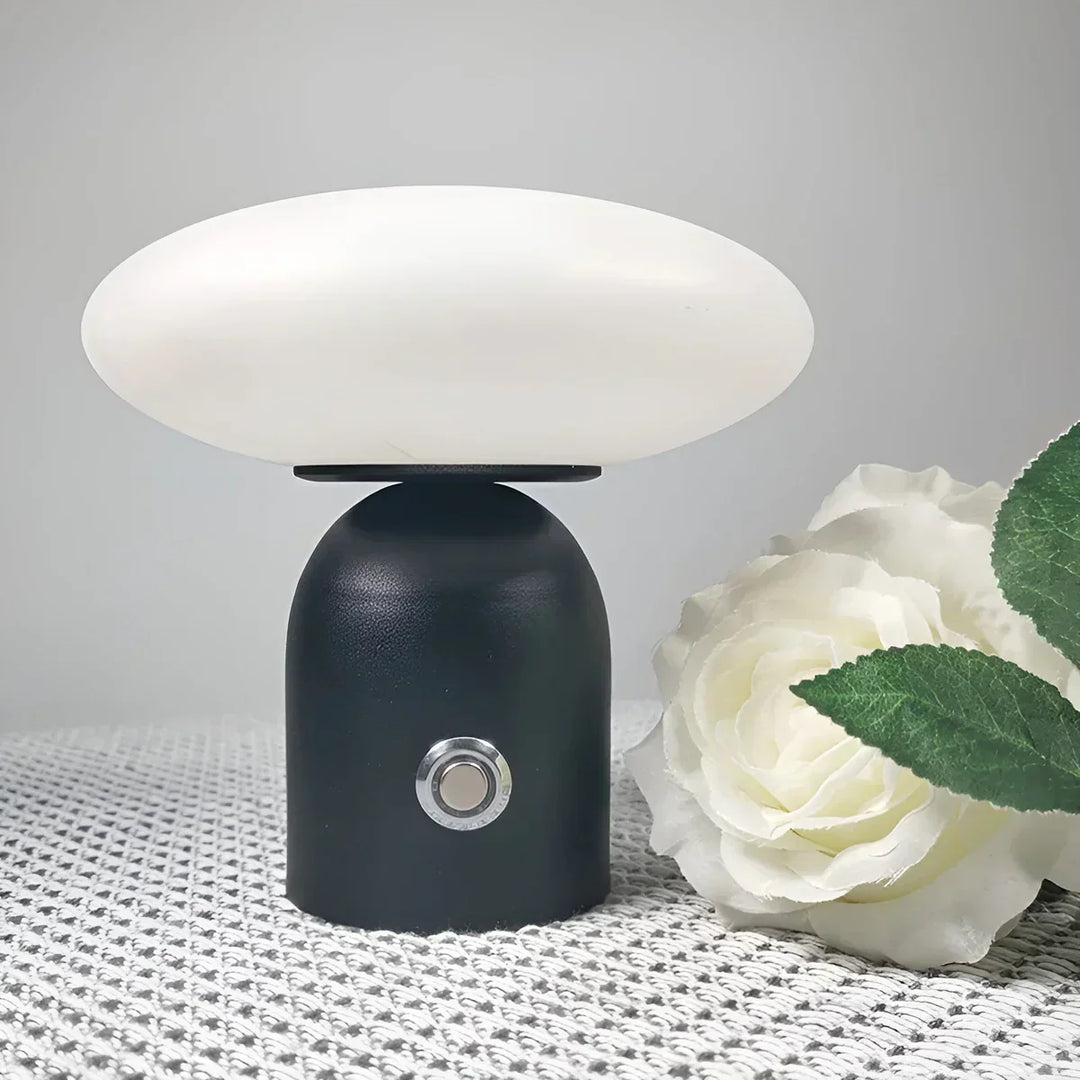 Sleek black mushroom table lamp, rechargeable and touch-controlled. A chic piece for Nordic home decor.