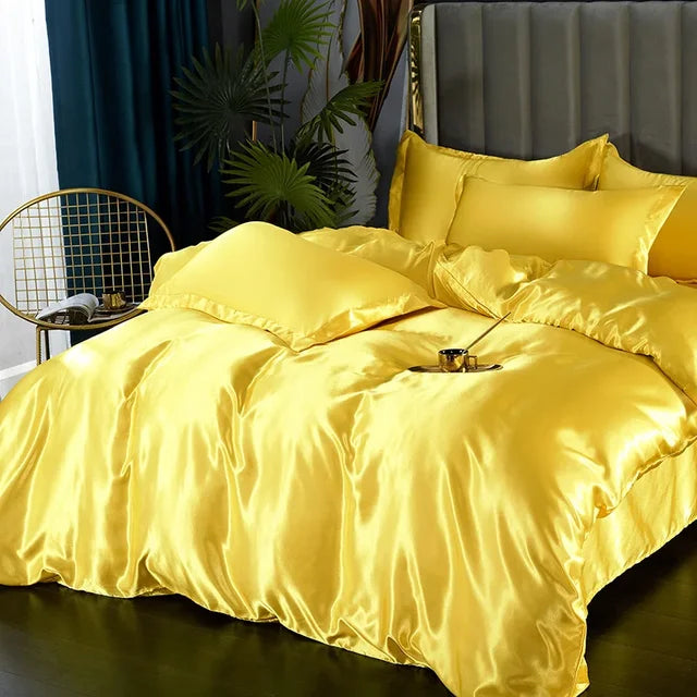 Soft satin bedding set in a light grey, adding a touch of elegance to bedroom decor.