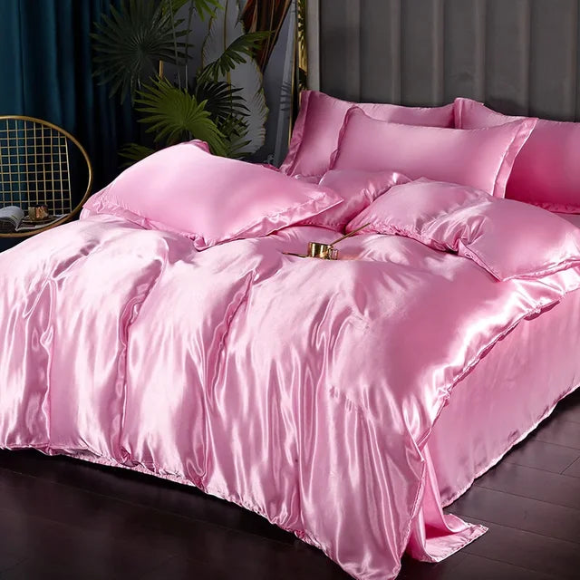 Complete luxury satin bedding ensemble, displayed neatly on a pristine white mattress.