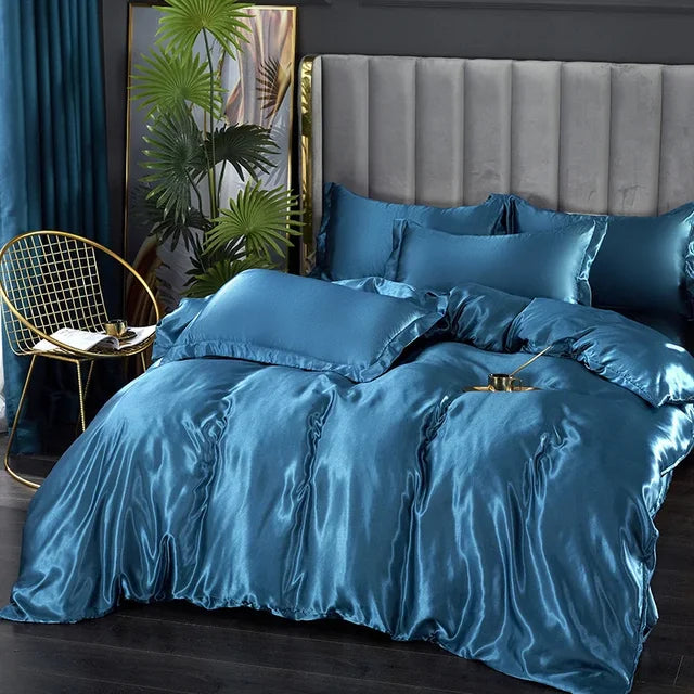 A cozy bedroom corner with a luxurious silky satin duvet cover and matching pillows.