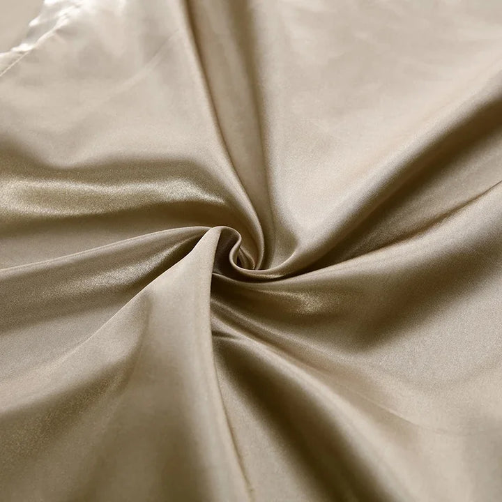 Luxury satin bedding set in a rich jewel tone, adding opulence to bedroom decor.