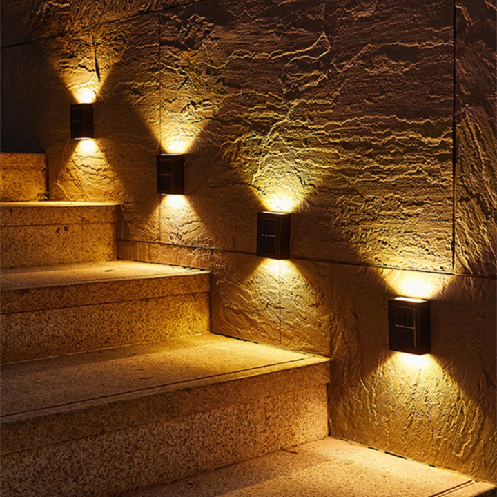Luxury solar LED wall light illuminates a modern outdoor patio, showcasing garden decor.