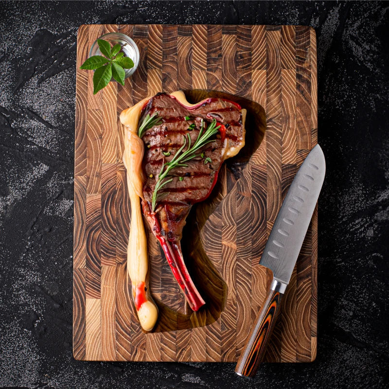 Durable teak wood cutting board, perfect for heavy-duty kitchen food prep. A natural and luxurious chef's tool.
