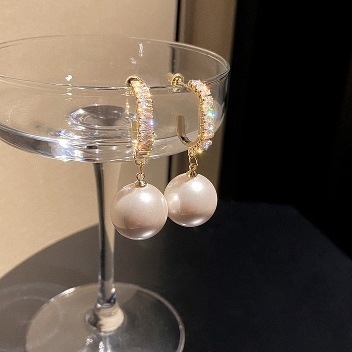 Elegant women's pearl & zirconia dangle earrings, a classic luxury jewelry piece for sophisticated style.