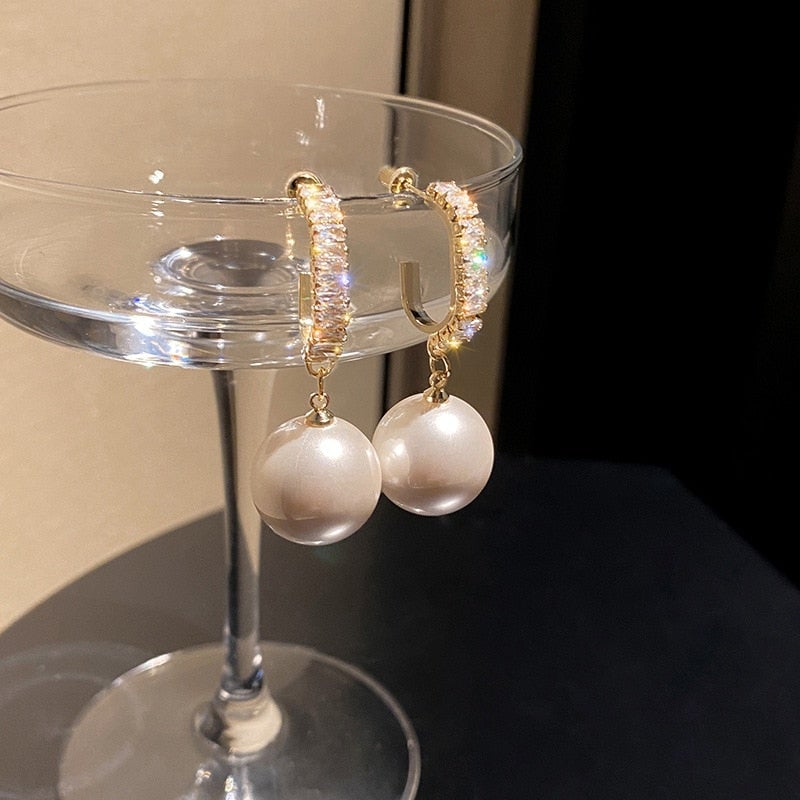 Glamorous women's luxury drop earrings with pearls & sparkling zirconia. Fashionable statement jewelry for her.