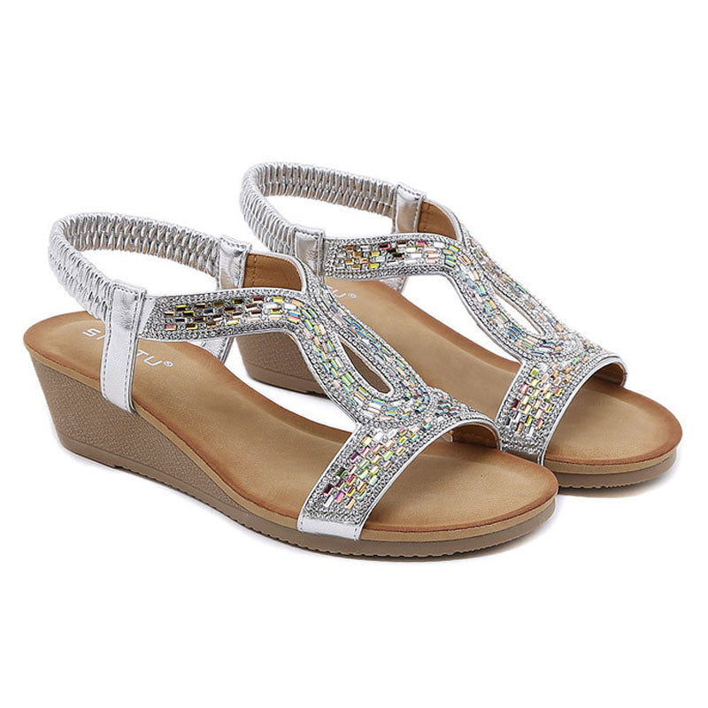 Pretty women's wedge sandals with an array of sparkling rhinestones for a radiant glow.