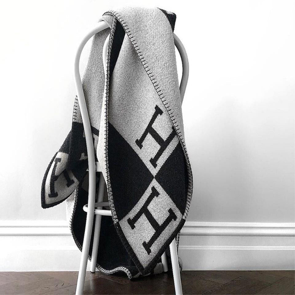 Sophisticated gray plaid wool cashmere throw, designed for luxury and comfort, an essential decorative throw.