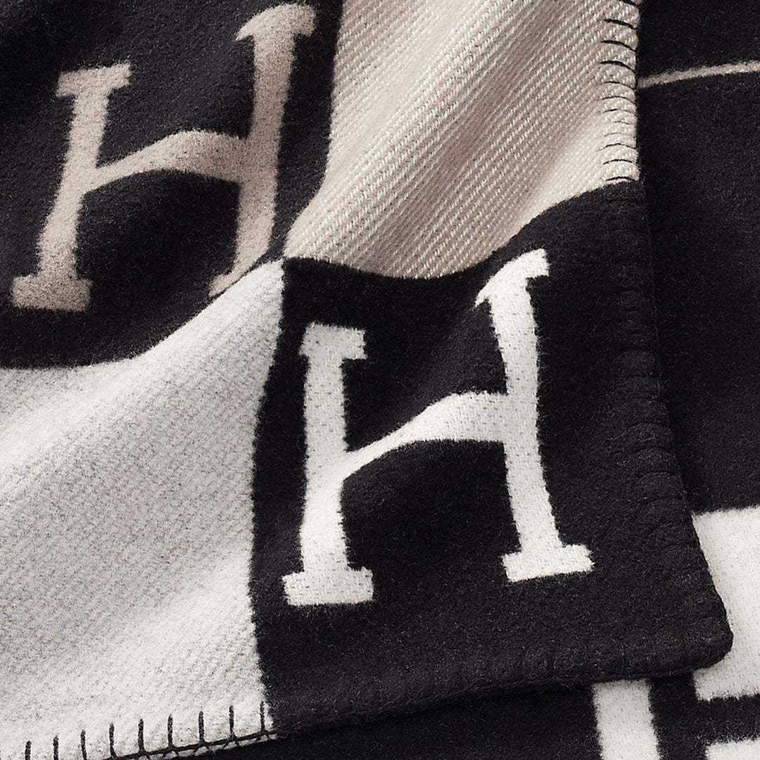 Richly textured wool & cashmere blend plaid throw, a soft blanket ideal for a cozy home atmosphere.