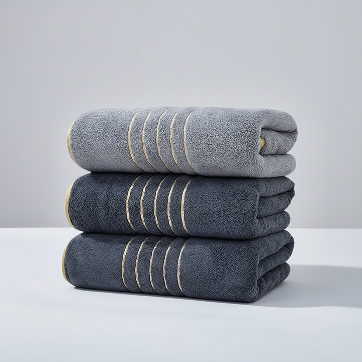 Stack of striped LuxuryWrap microfiber towels, a luxurious and absorbent bath linen set