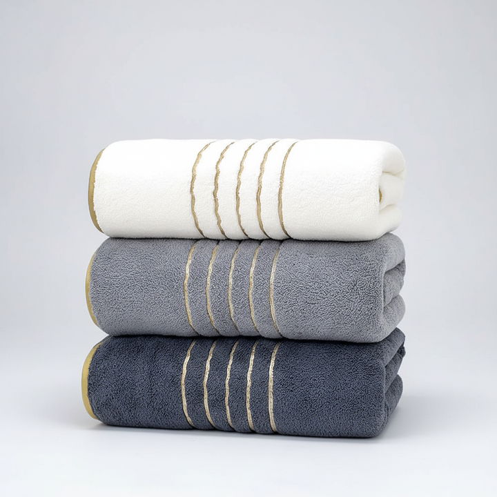 LuxuryWrap bath towel set featuring two striped towels and a hand towel, perfect for modern bathroom decor.