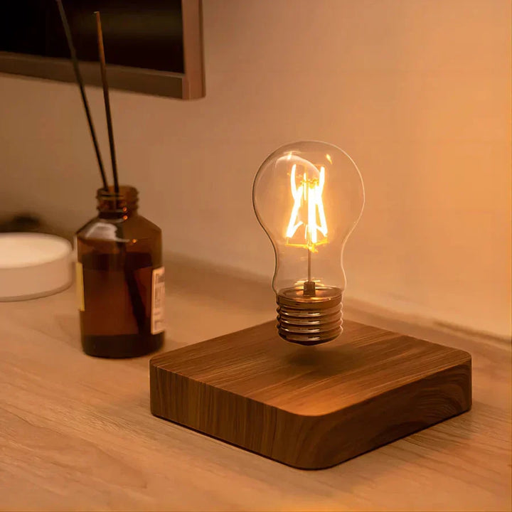 Novelty magnetic light bulb floating above a solid walnut wood base, home decor