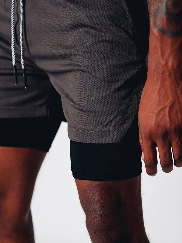 Group of men's athletic 2-in-1 shorts folded, showing quick dry fabric and design.