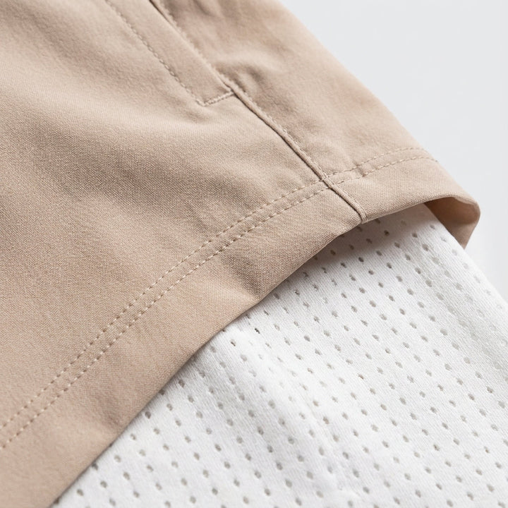 Close-up of the phone pocket on men's black 2-in-1 athletic performance training shorts.