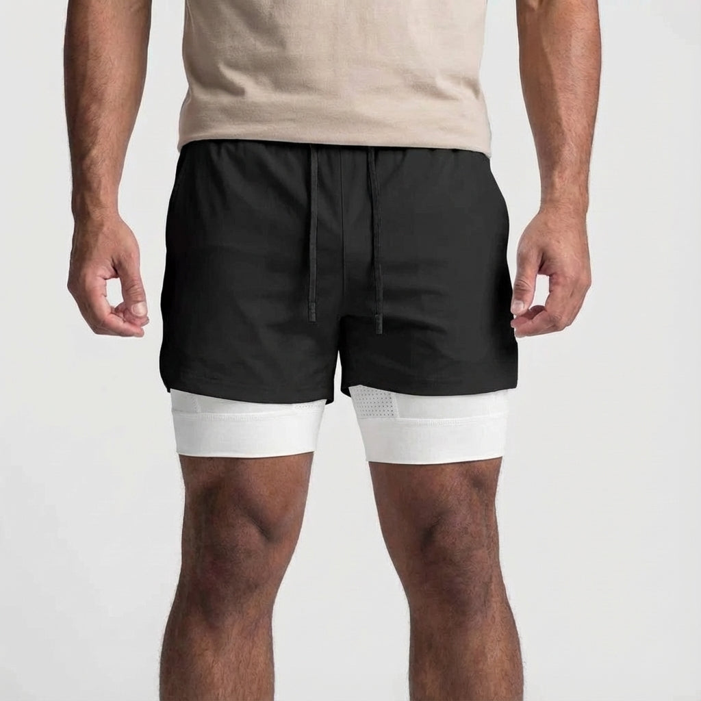 Stack of men's black 2-in-1 athletic performance training shorts with phone pocket.