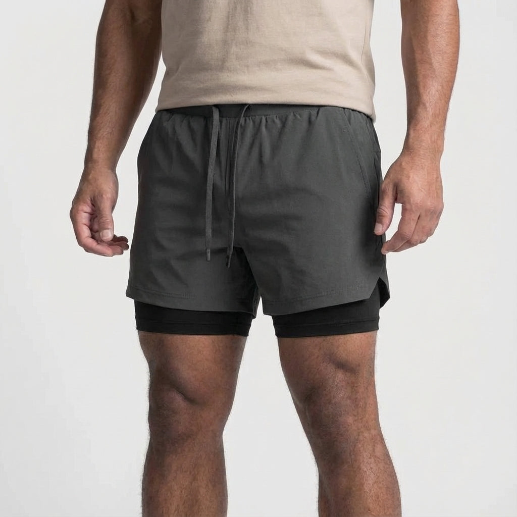Detail of moisture-wicking fabric on men's black 2-in-1 performance training shorts.
