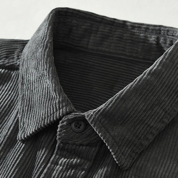 Relaxed fit men's button-up shirt showcasing a vibrant abstract patchwork design. Ideal casual top.