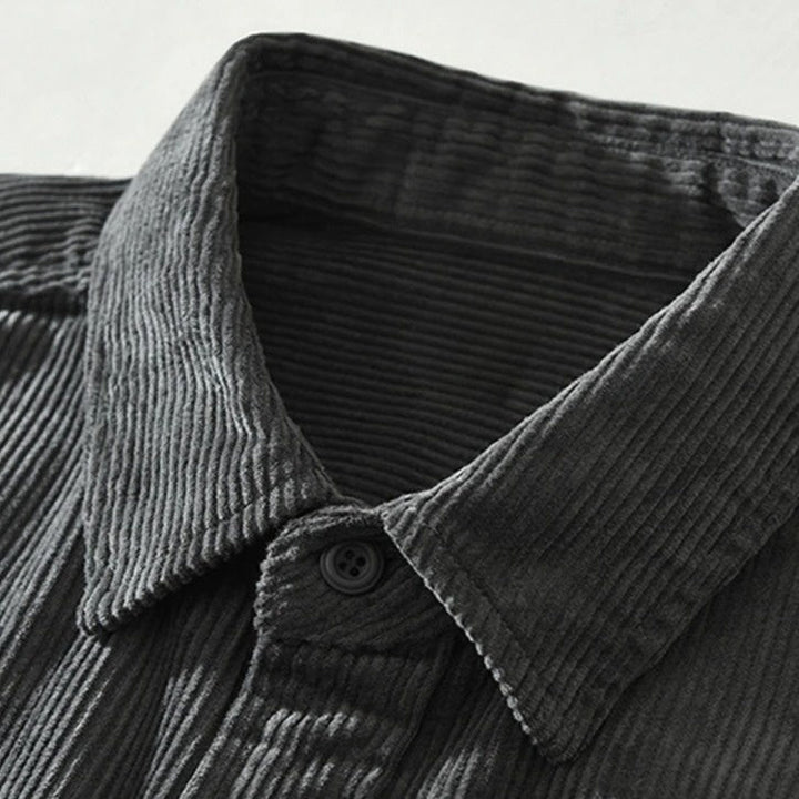 Relaxed fit men's button-up shirt showcasing a vibrant abstract patchwork design. Ideal casual top.