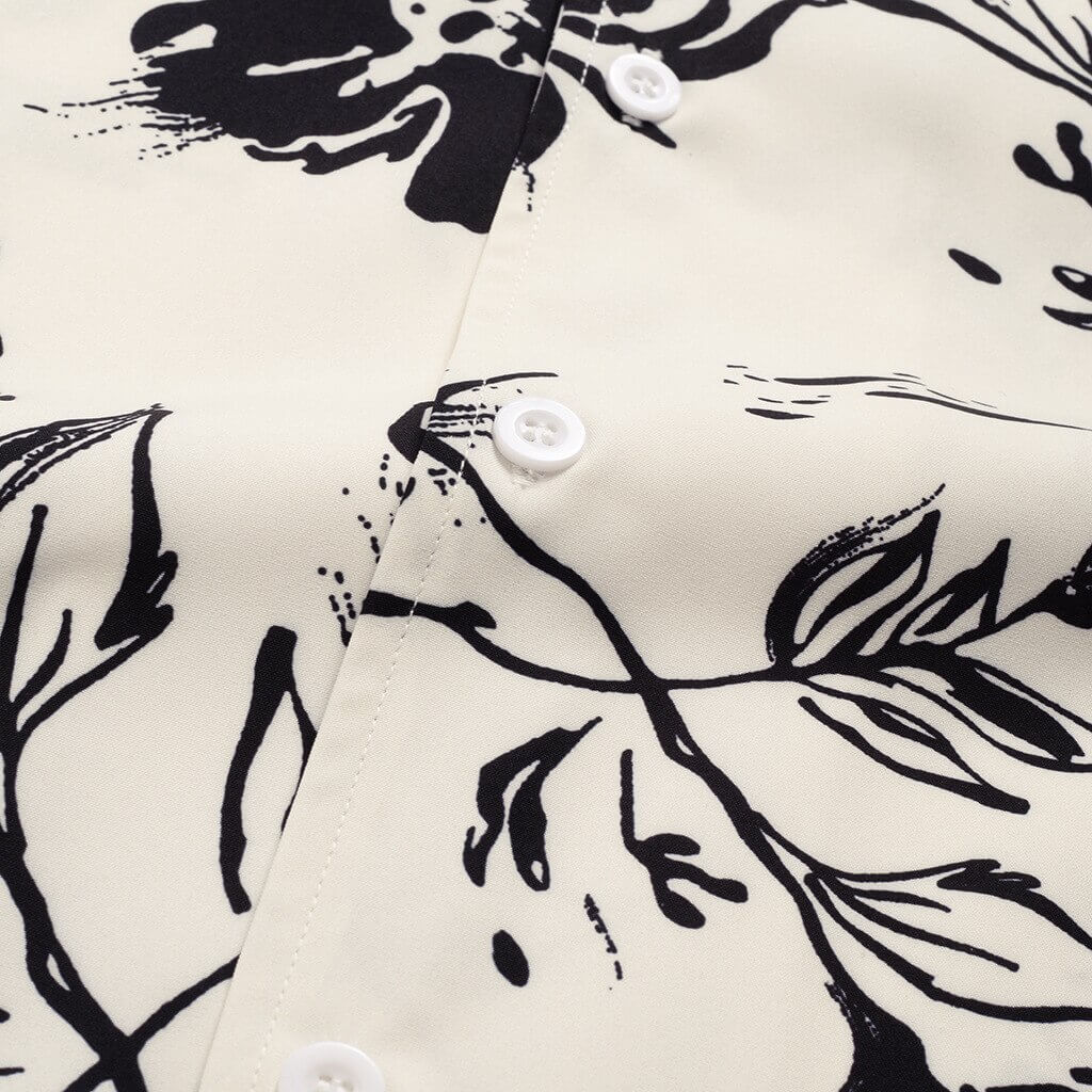 Texture shot of men's polyester tropical short sleeve shirt, emphasizing breathability for summer fashion.