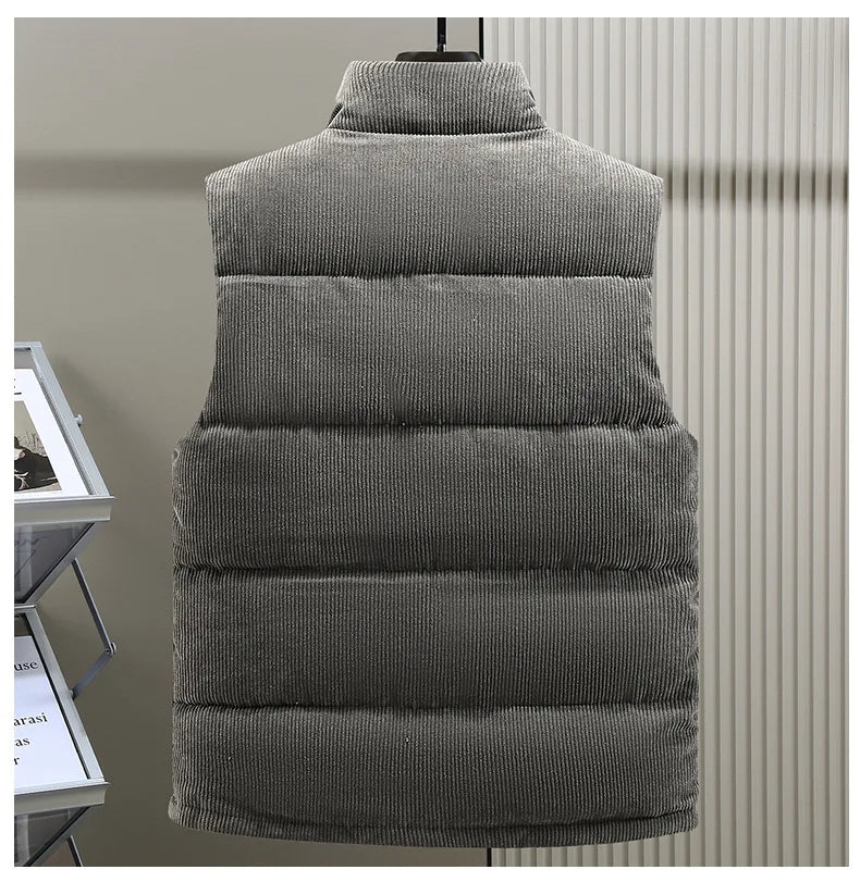 Stylish man wearing Alpine ribbed puffer vest over a long-sleeve shirt, perfect fall fashion layering.