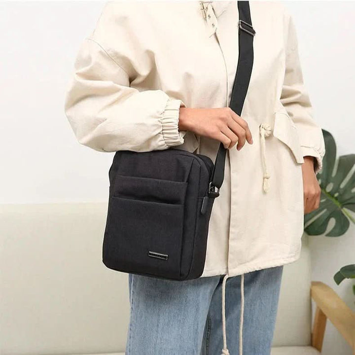 Compact anti-theft shoulder bag for men, waterproof & durable, designed for secure daily carry.